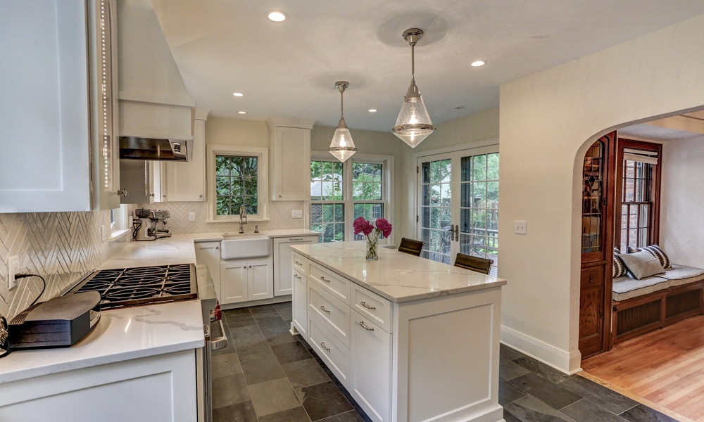 Kitchen remodel in the Twin Cities installed by design-construction team at Titus Contracting features a large eat-in enameled island with pendant lights.