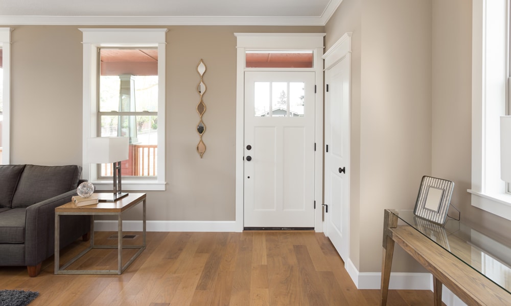 Entryway design with white doors and trim and hardwood flooring.