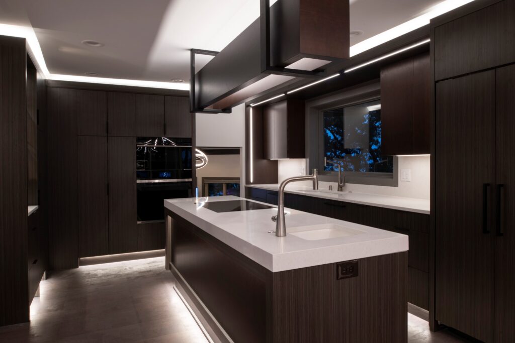 a beautiful kitchen with dark laminate cabinets and white countertops