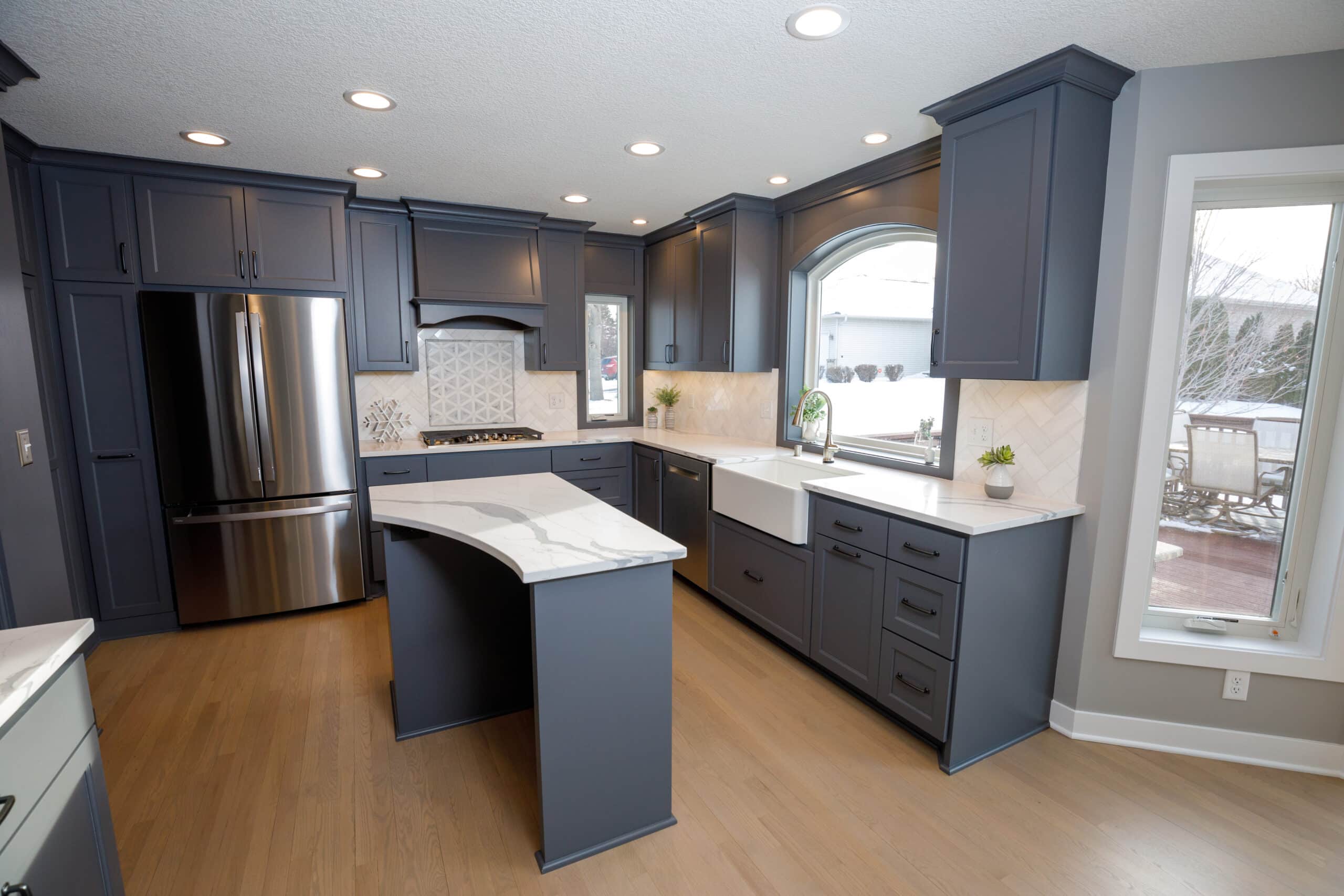 Blue kitchen with white quartz countertops