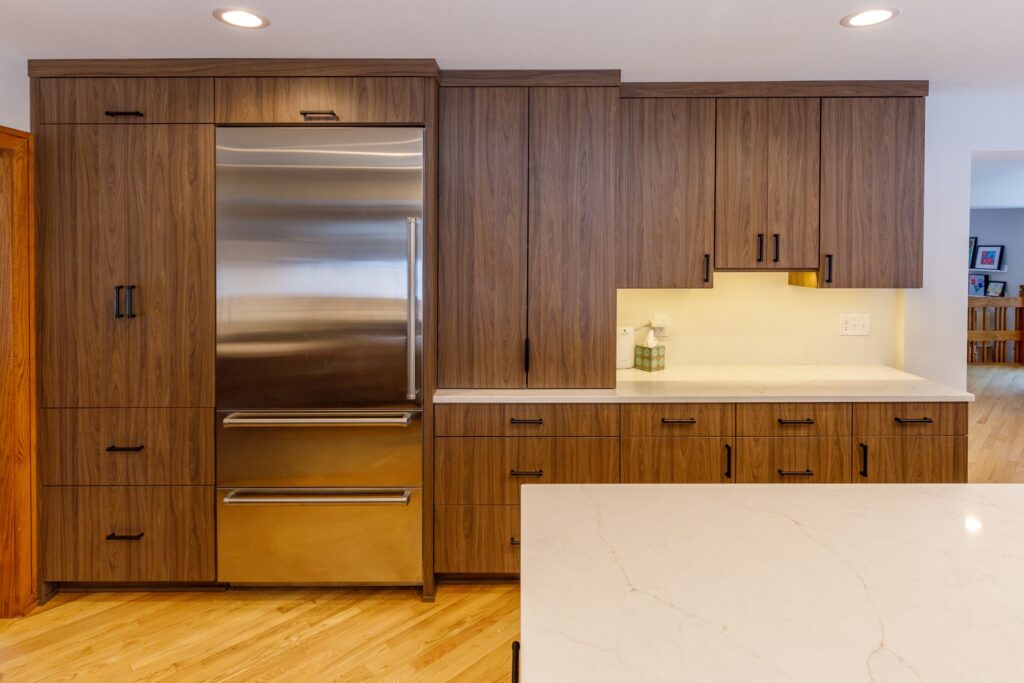 a kitchen with beautiful brown laminate cabinets and a luxury refrigerator 
