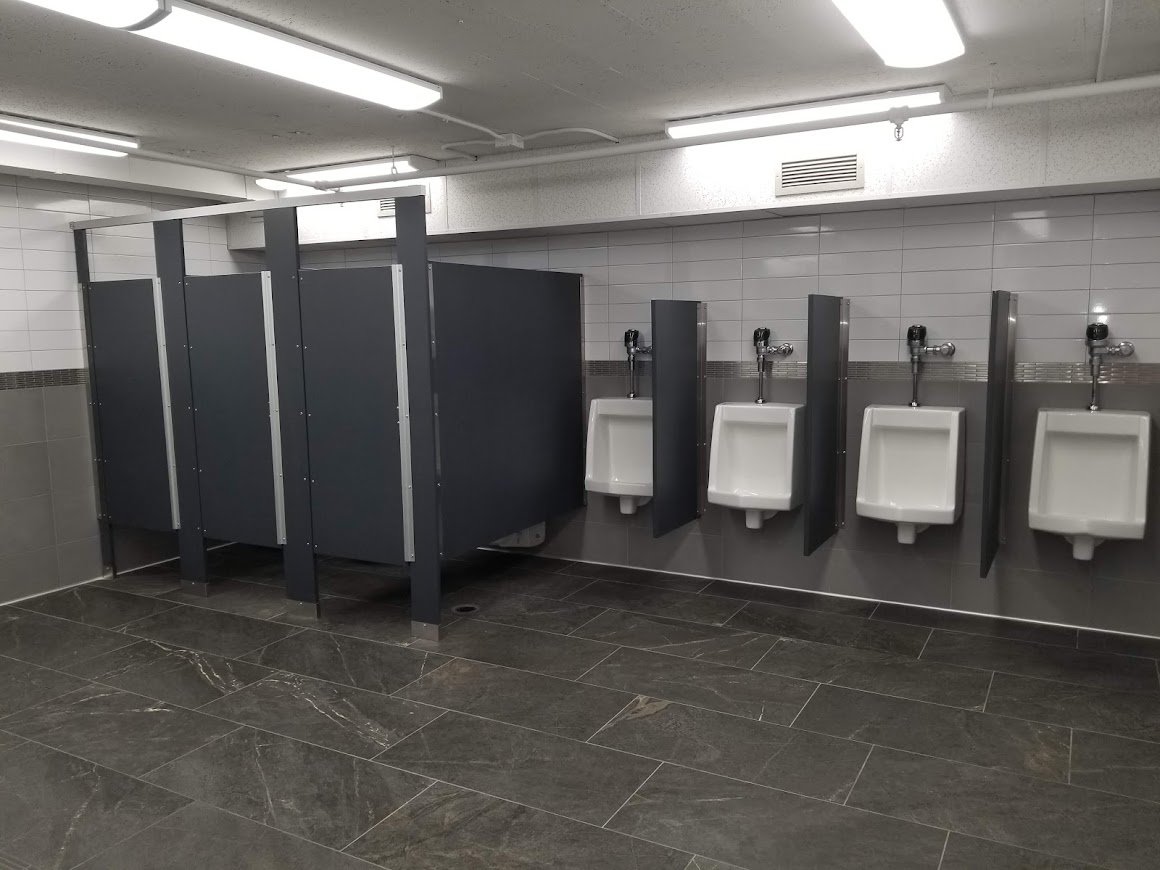 commercial bathroom with stalls and urinals