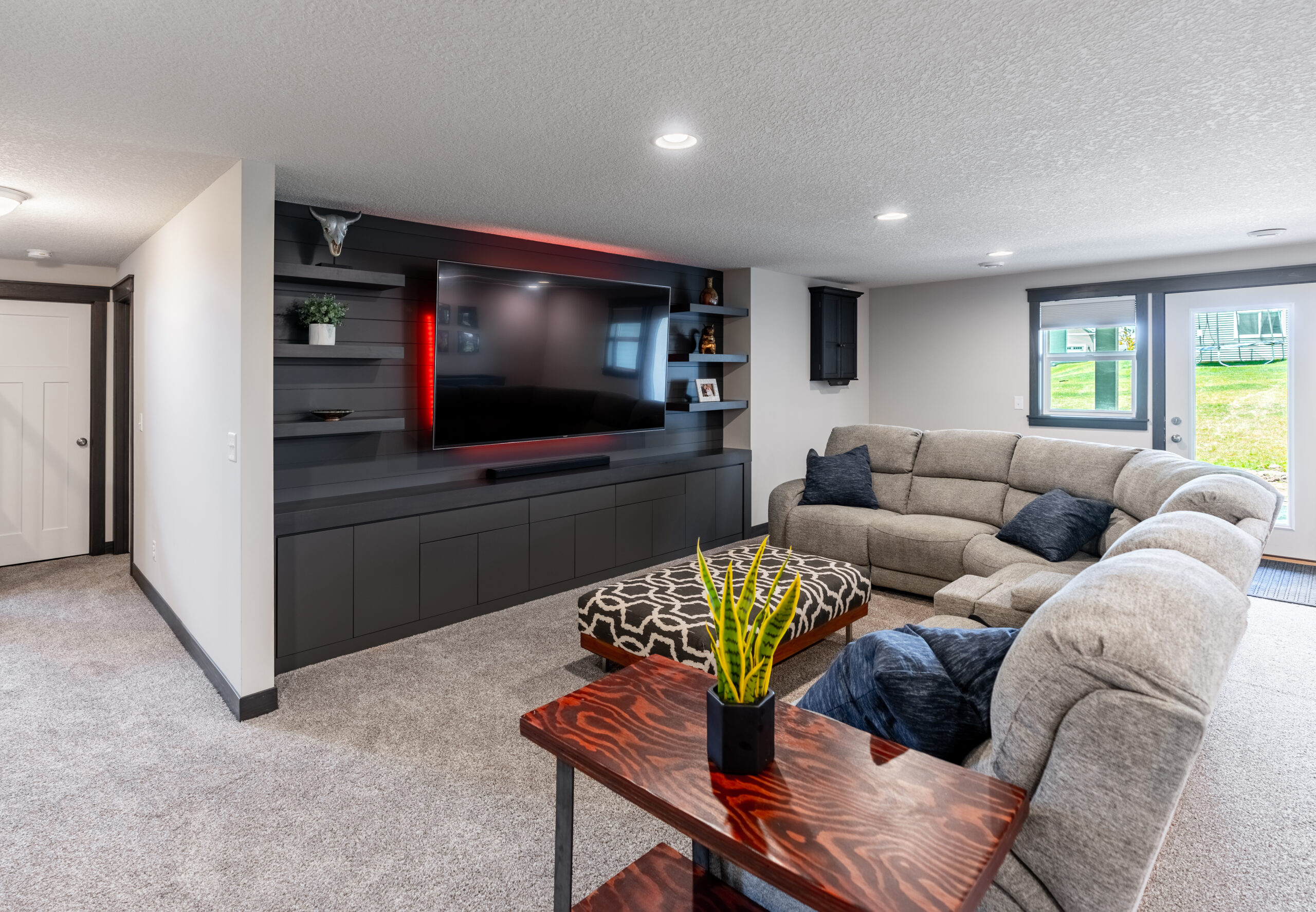 basement with large TV and couch