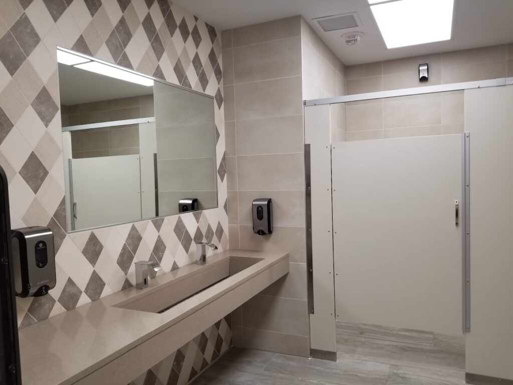 commercial bathroom with unique wall tiles
