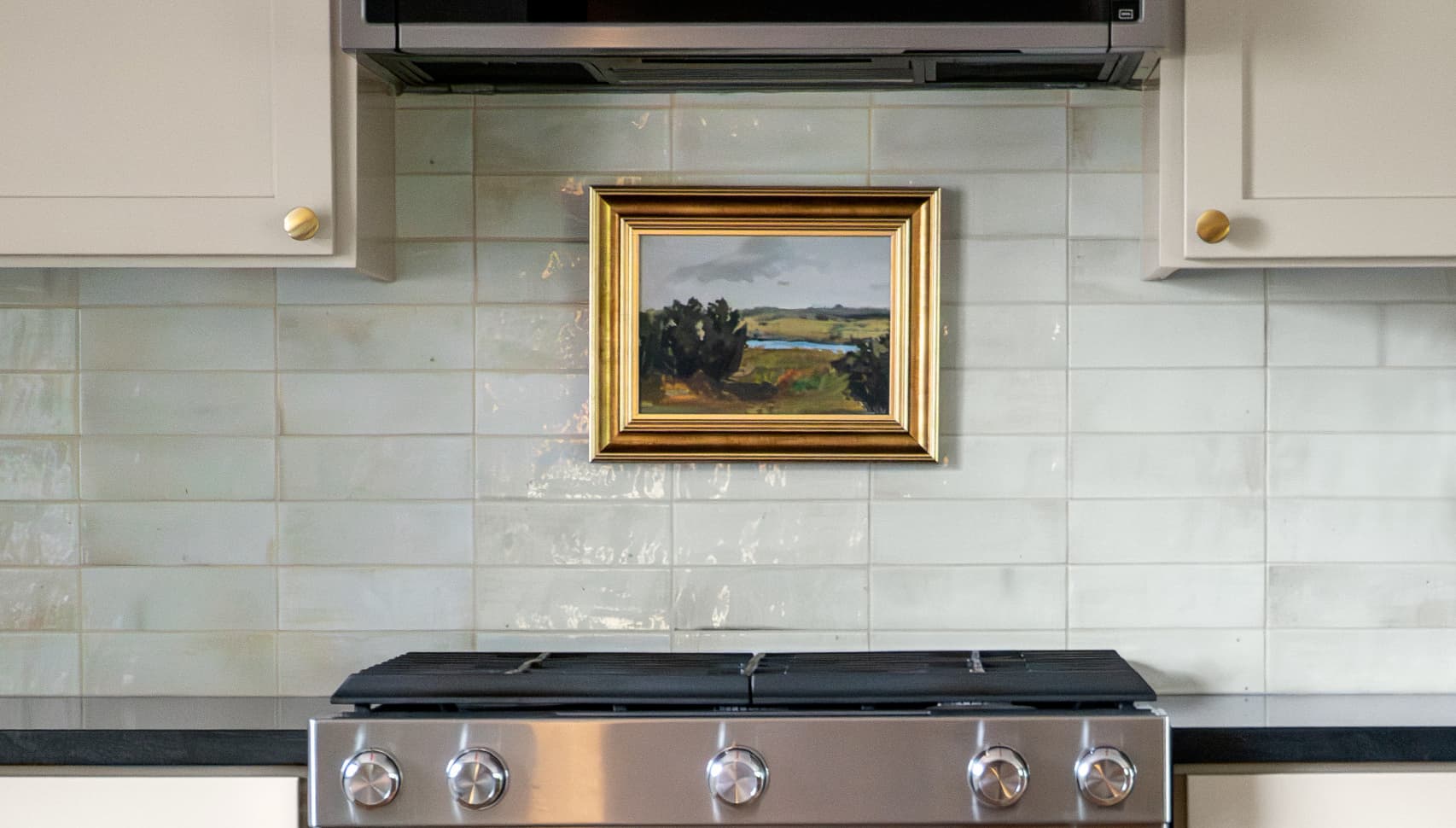 kitchen with hidden storage behind a painting