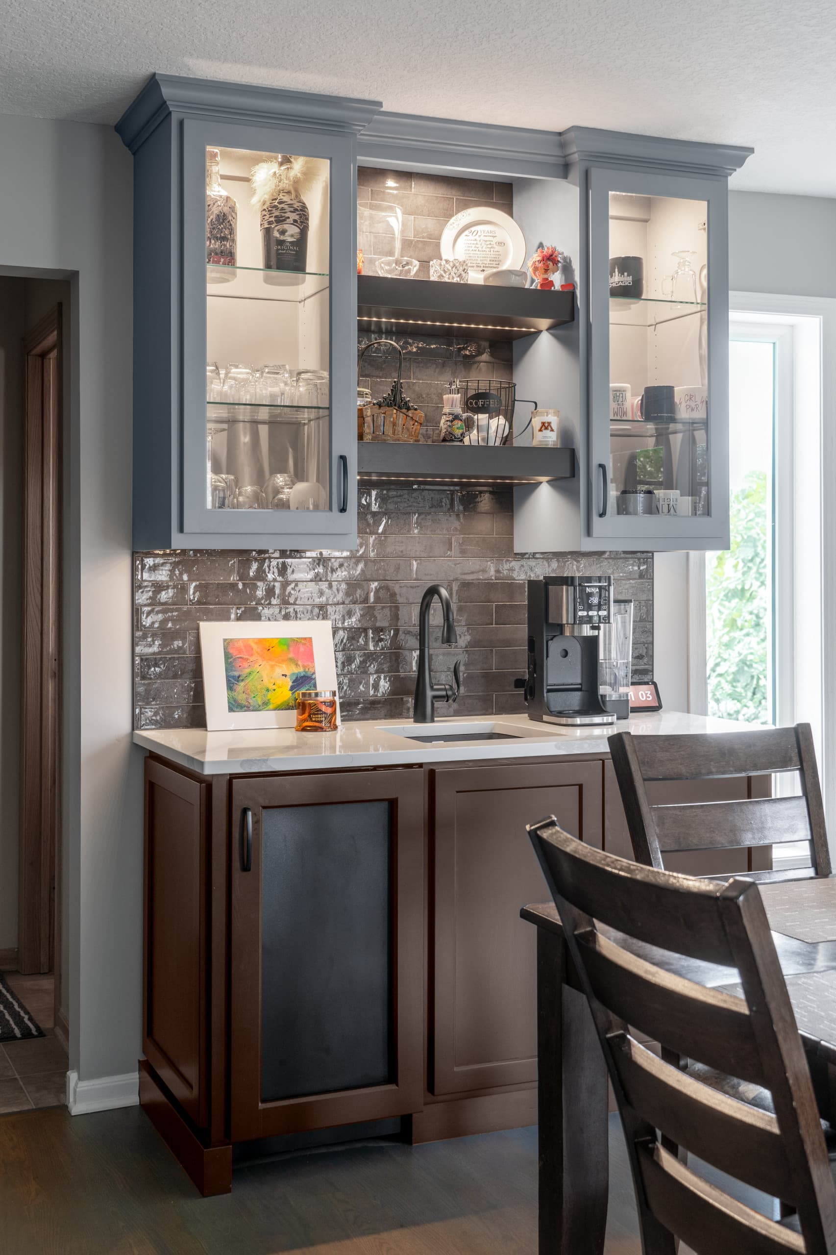 a kitchen bar with under counter lights and inside cabinet lights