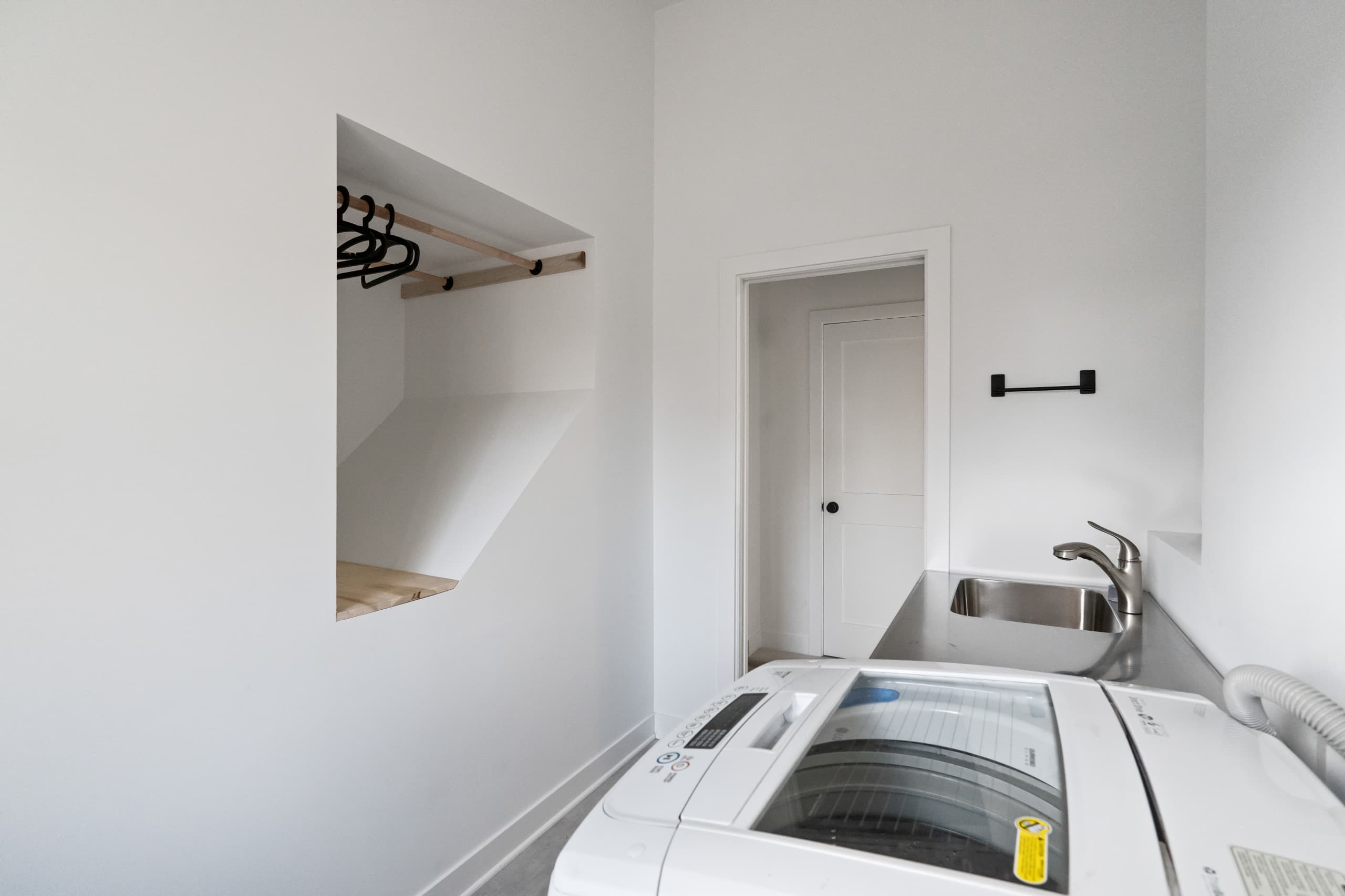 a laundry room with a storage alcove