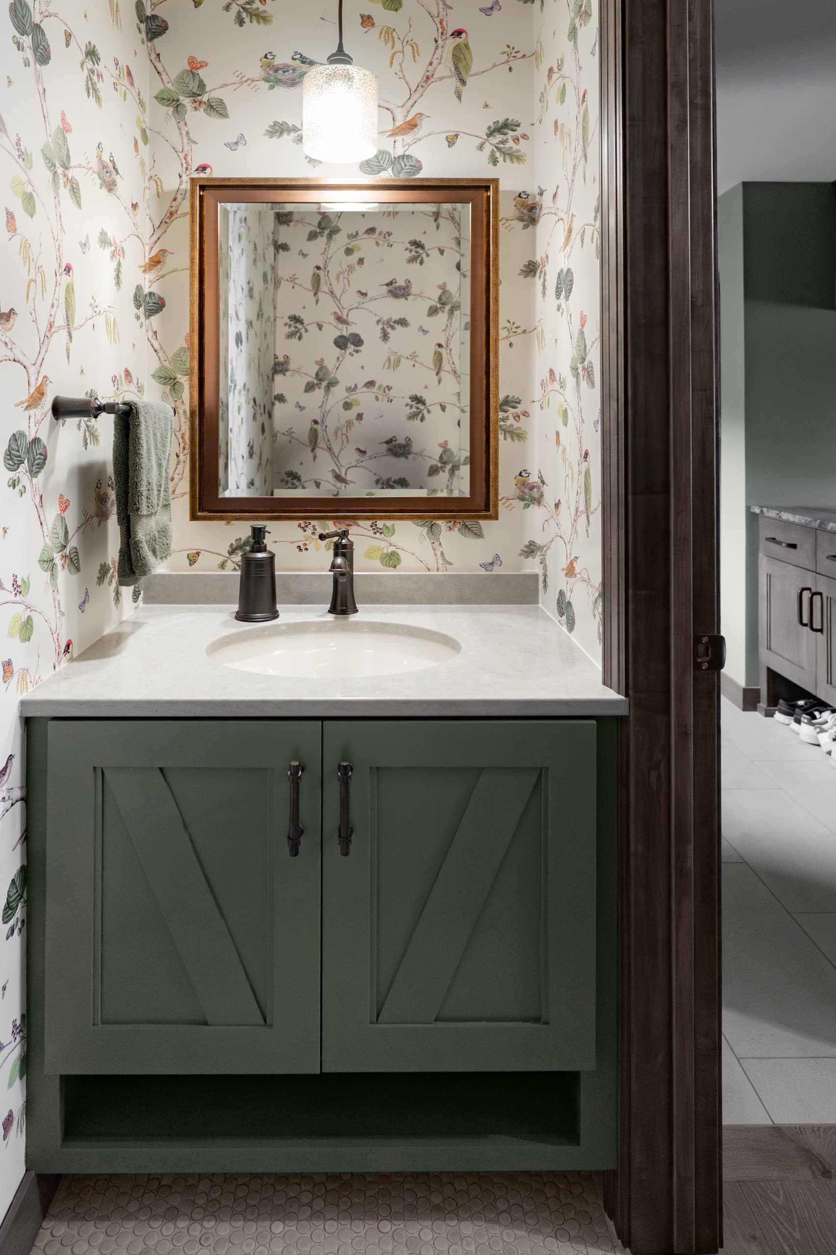 a powder room with a distinct wallpaper - birds rest of nests surrounded by leafs