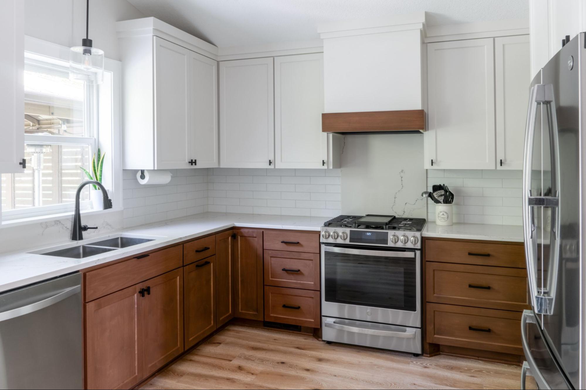 a kitchen with white and brown cabinets