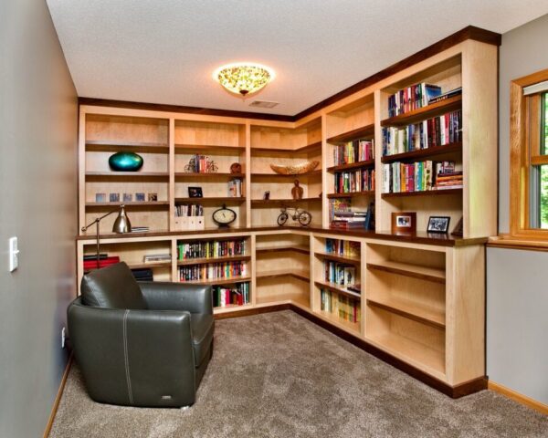 a home library with ceiling-to-floor shelves and a cozy recliner.