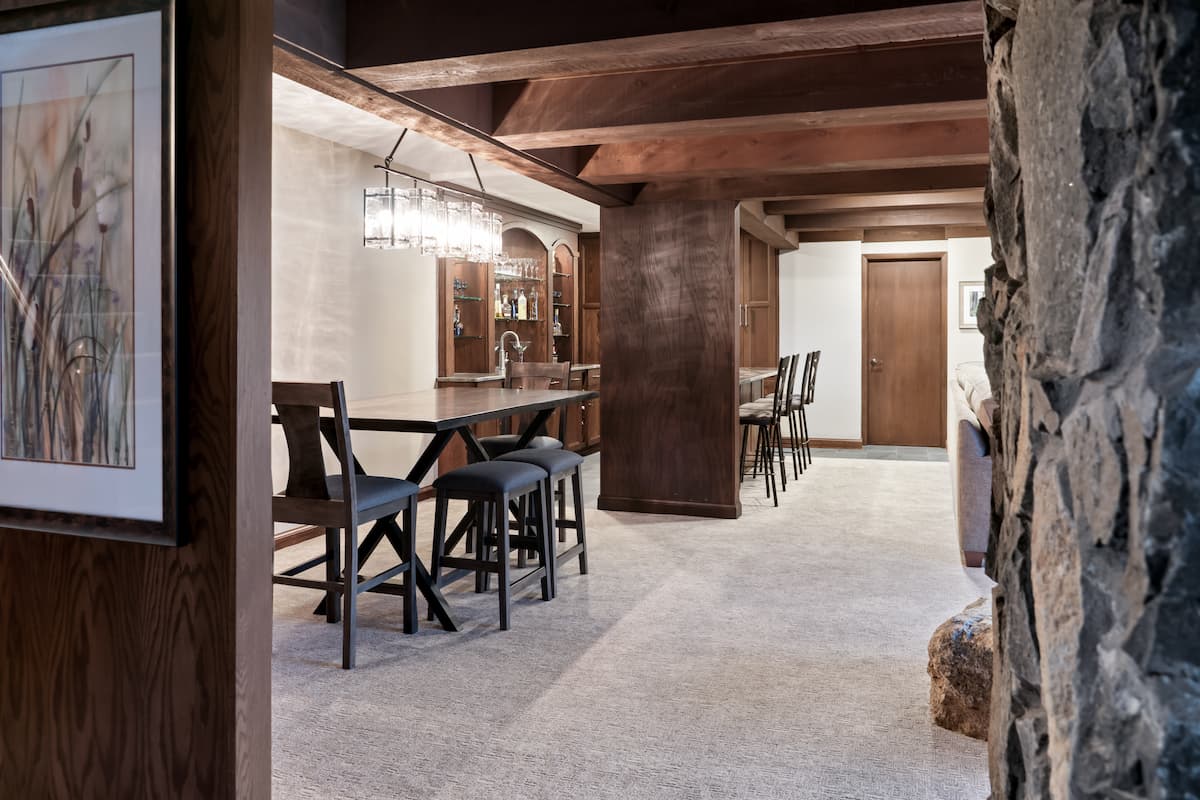 basement renovation with bar, seating and natural elements in burnsville, MN