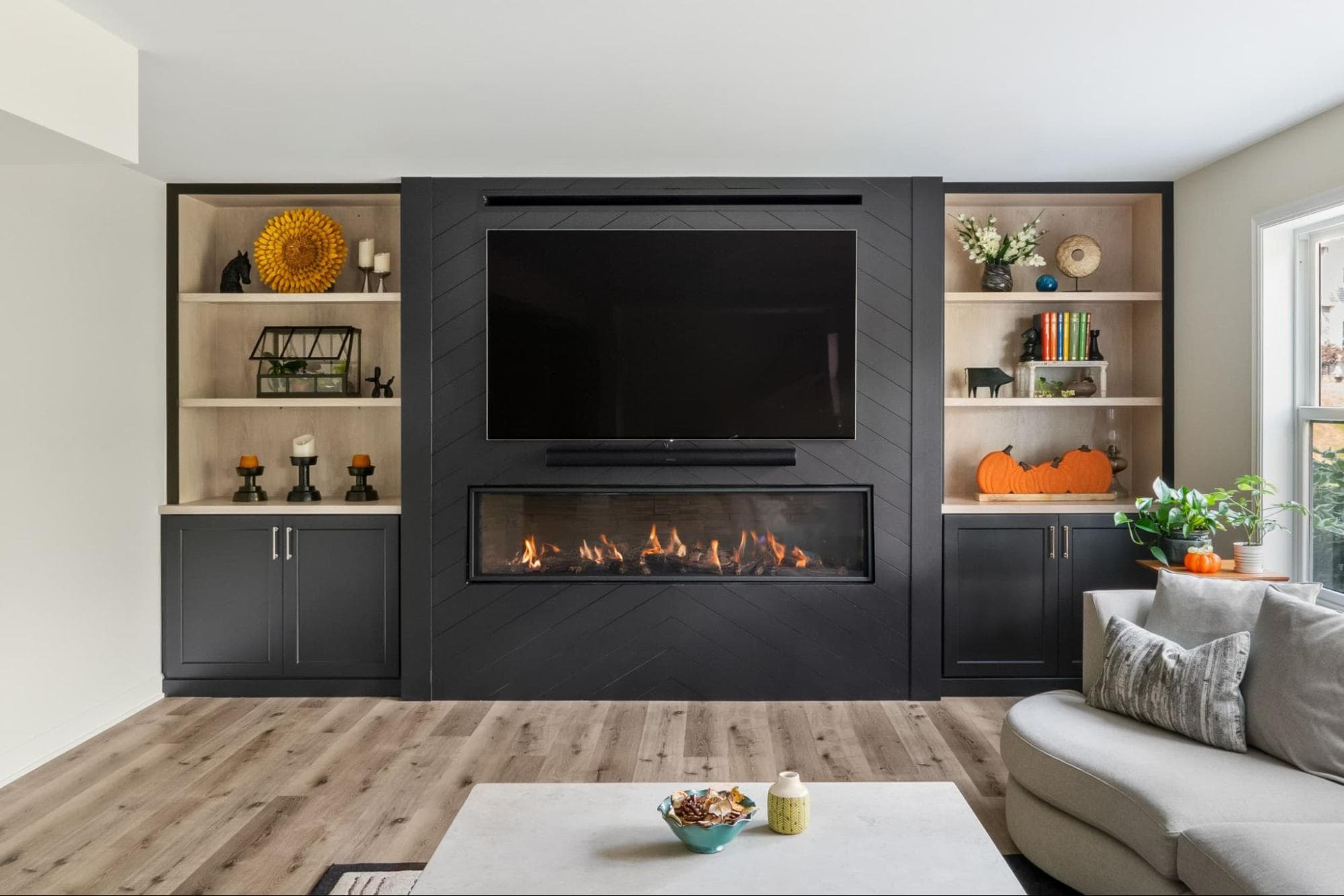 basement with large built-in shelves around a fireplace