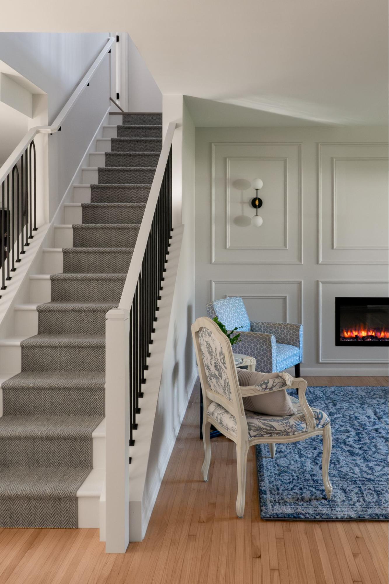 a white staircase with black railing