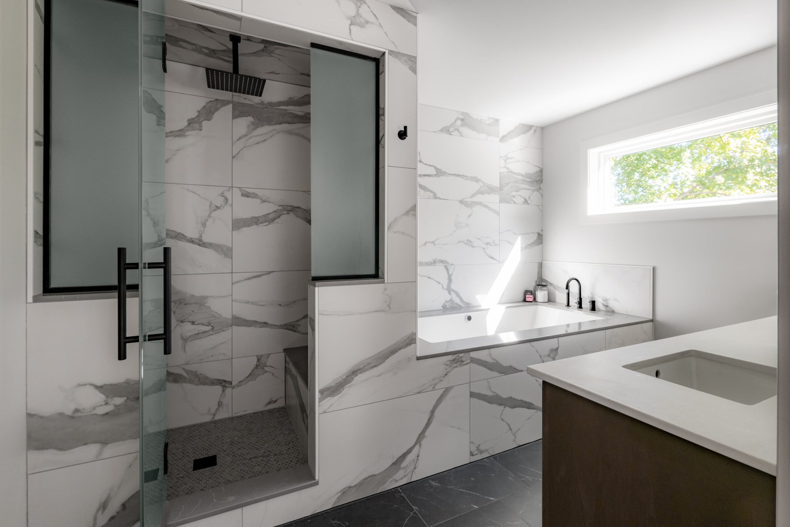 bathroom with large white and gray tiles