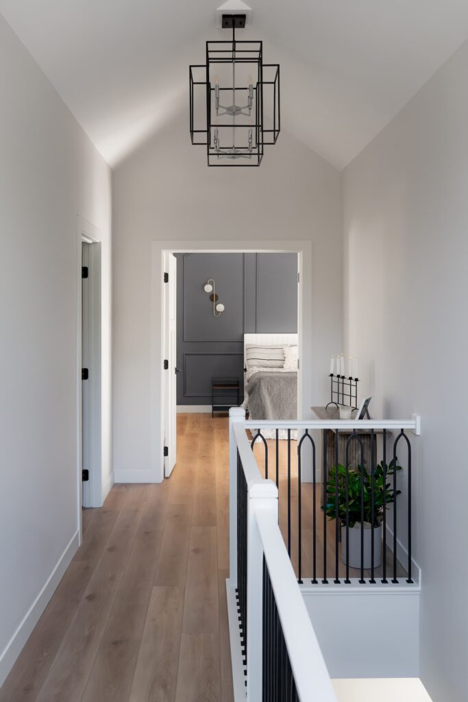 interior of an upper landing with high vaulted ceilings and a view into bedrooms